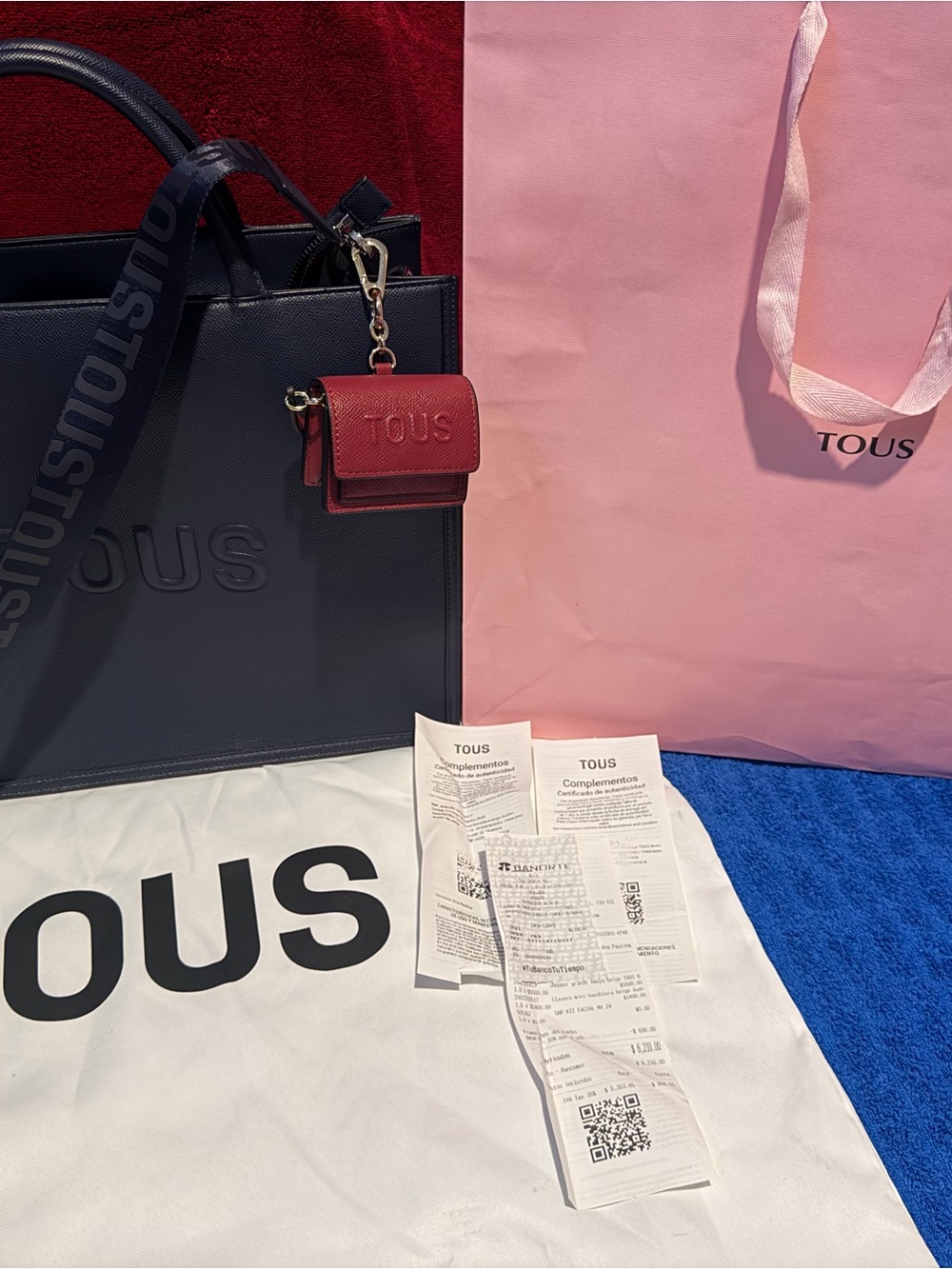 TOUS navy leather tote with burgundy charm accessory